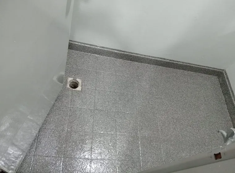 Grey flake epoxy floor coating over tiles